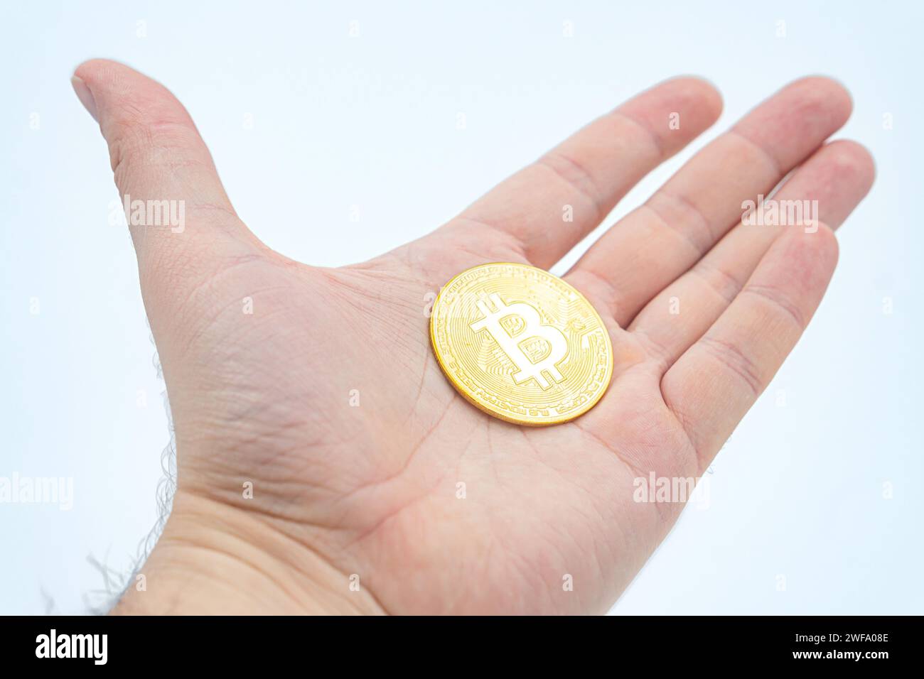 Open palm handful of bitcoins as a concept of openness to new technologies and cryptocurrencies as well as investing in mining and halving. Holding Bi Stock Photo