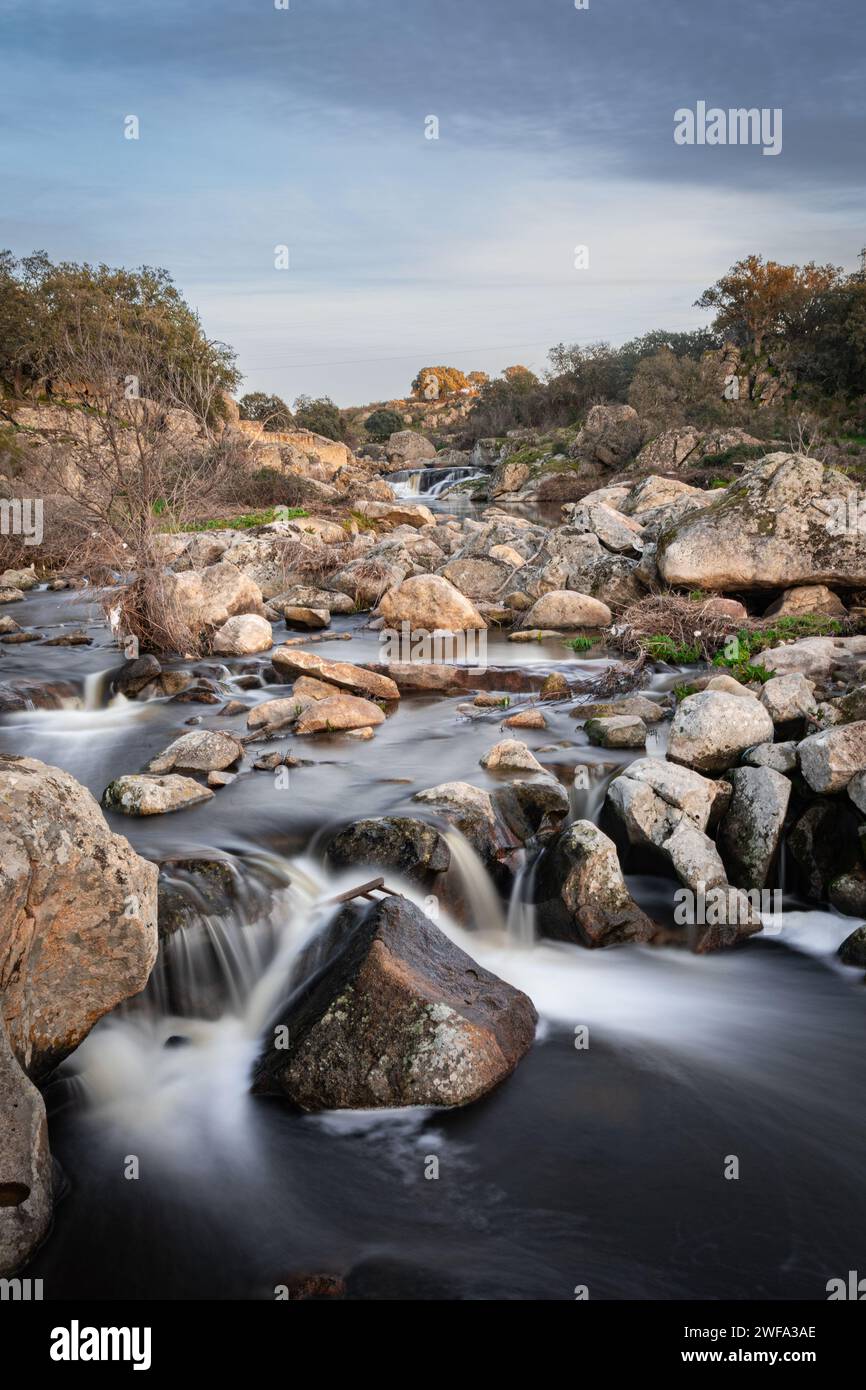 The river Salor flowing towards the reservoir of El Gallo. Long exposure photograph. Stock Photo