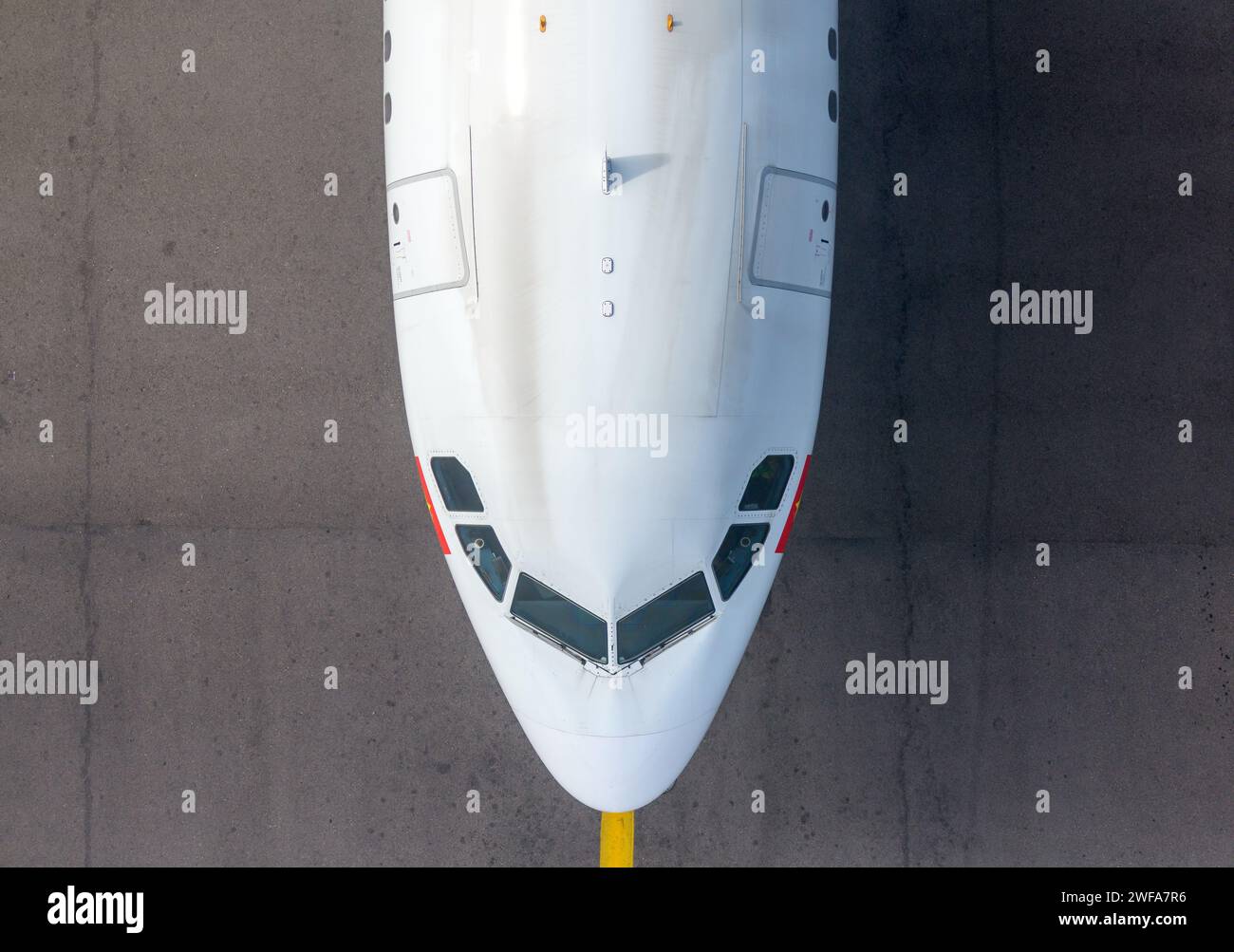 Top down view of Airbus aircraft taxiing underneath Hong Kong Airport Sky Bridge, also know as Chek Lap Kok Sky Deck, above a taxiway. Stock Photo