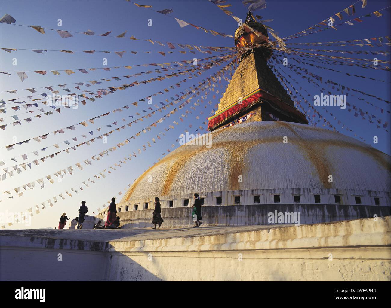 Worshippers parade around the Great Stupa in the Tibetan quarter at ...