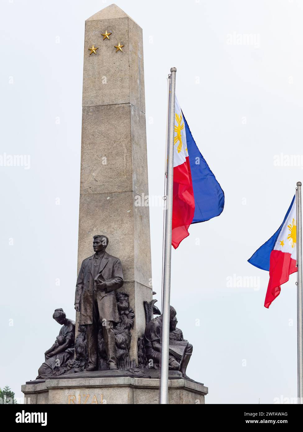 The Jose Rizal Monument and the flag of the Philippines at Rizal Park along Roxas Boulevard in Manila, Philippines. Stock Photo