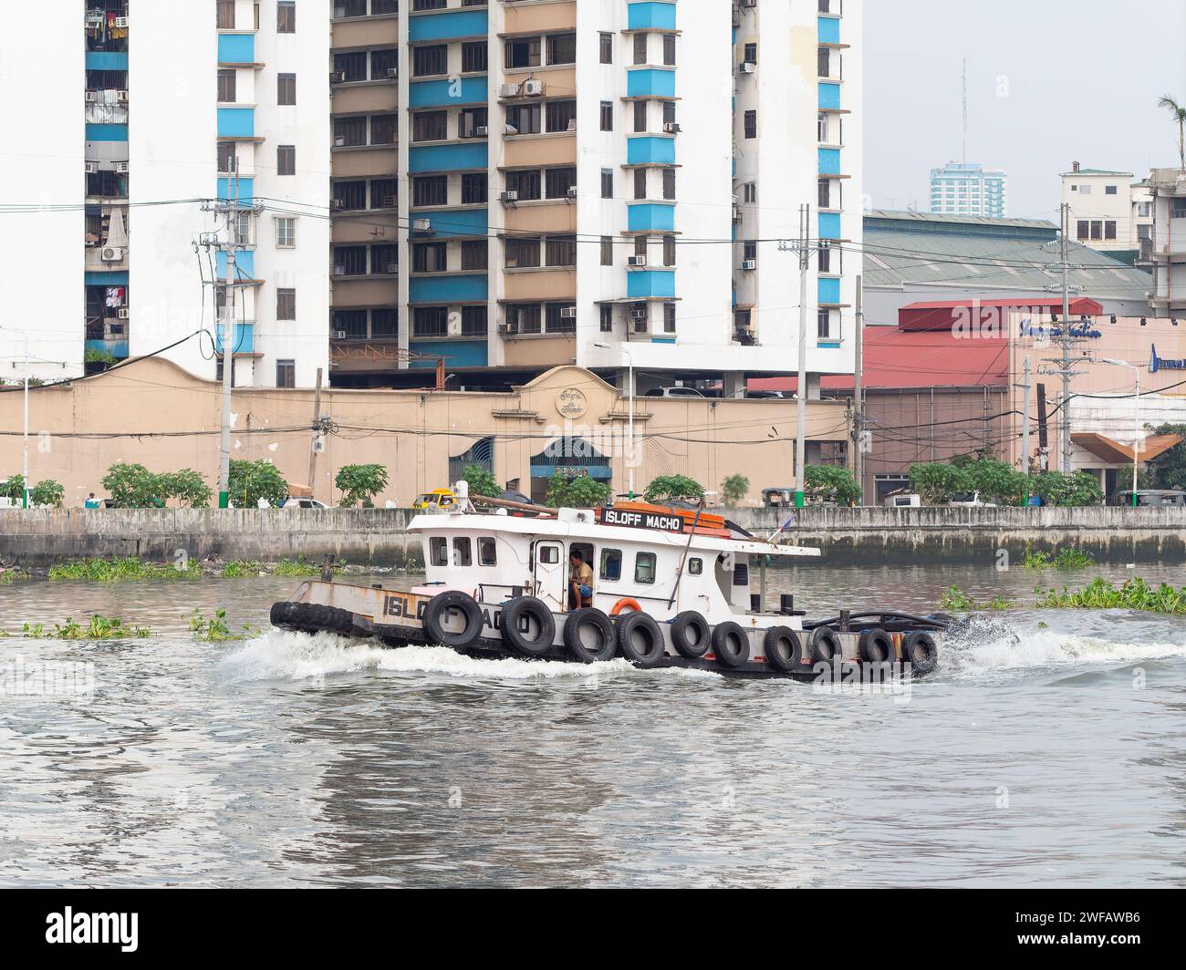 Tugboat navigating Pasig River near Intramuros in Manila, the capital 