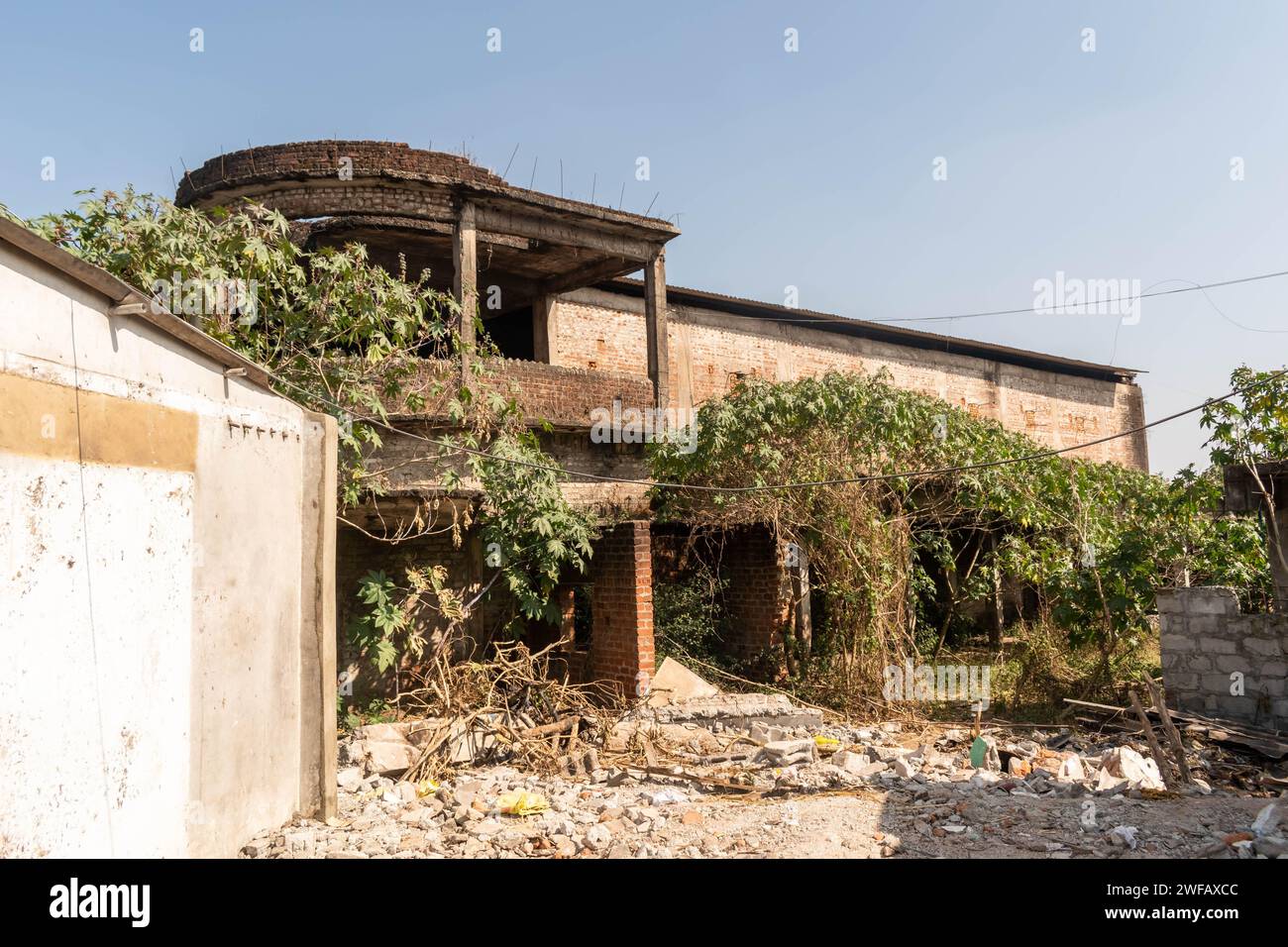 Belur, Karnataka, India - January 9 2023: An old derelict overgrown ruin of a row house in the town. Stock Photo