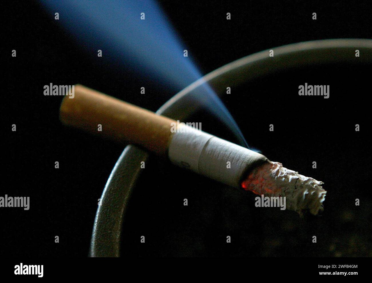 File photo dated 14/06/2007 of a cigarette burning on an ashtray. The number of smokers in Northern Ireland has dropped from a quarter of the population to 14%, but concern remains around prevalence among the most vulnerable. The Auditor General Dorinnia Carville also expressed concern at a rise in the numbers who vape - from 5% to 9% of adults in the last 10 years, and an estimated 9% of 11 to 16-year-olds as well as 24% of Year 12 students. Issue date: Tuesday January 30, 2024. Stock Photo