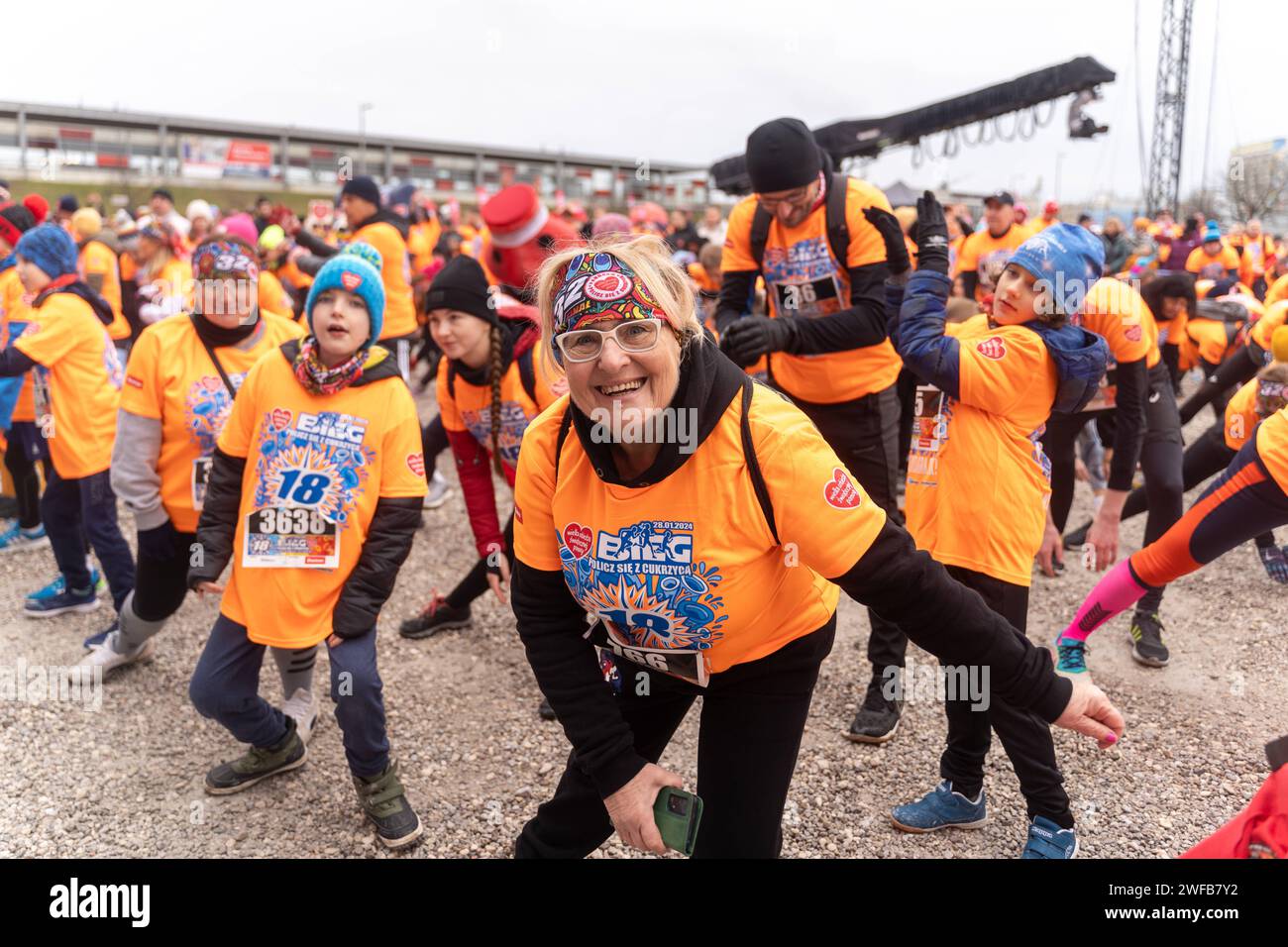 In the photo we see the participants of the Count with Diabetes Run warming up for the run during the 32nd final of charity action of the Great Orchestra of Christmas Charity Foundation Wielka Orkiestra Swiatecznej Pomocy - WOSP in Polish on January 28, 2024 in Warsaw, Poland. The Great Orchestra of Christmas Charity is the biggest Polish private charity organisation, which each year in January since 1992, collects money to provide financial aid for the Polish public health care system. According to initial reports in 2024 the Orchestra gathered at least 175 million zloty ca. 43 million US dol Stock Photo