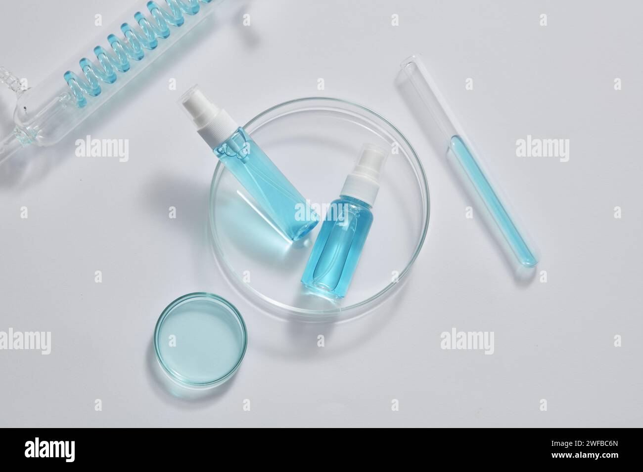 Top view of unlabeled mist spray bottles placed on a transparent dish