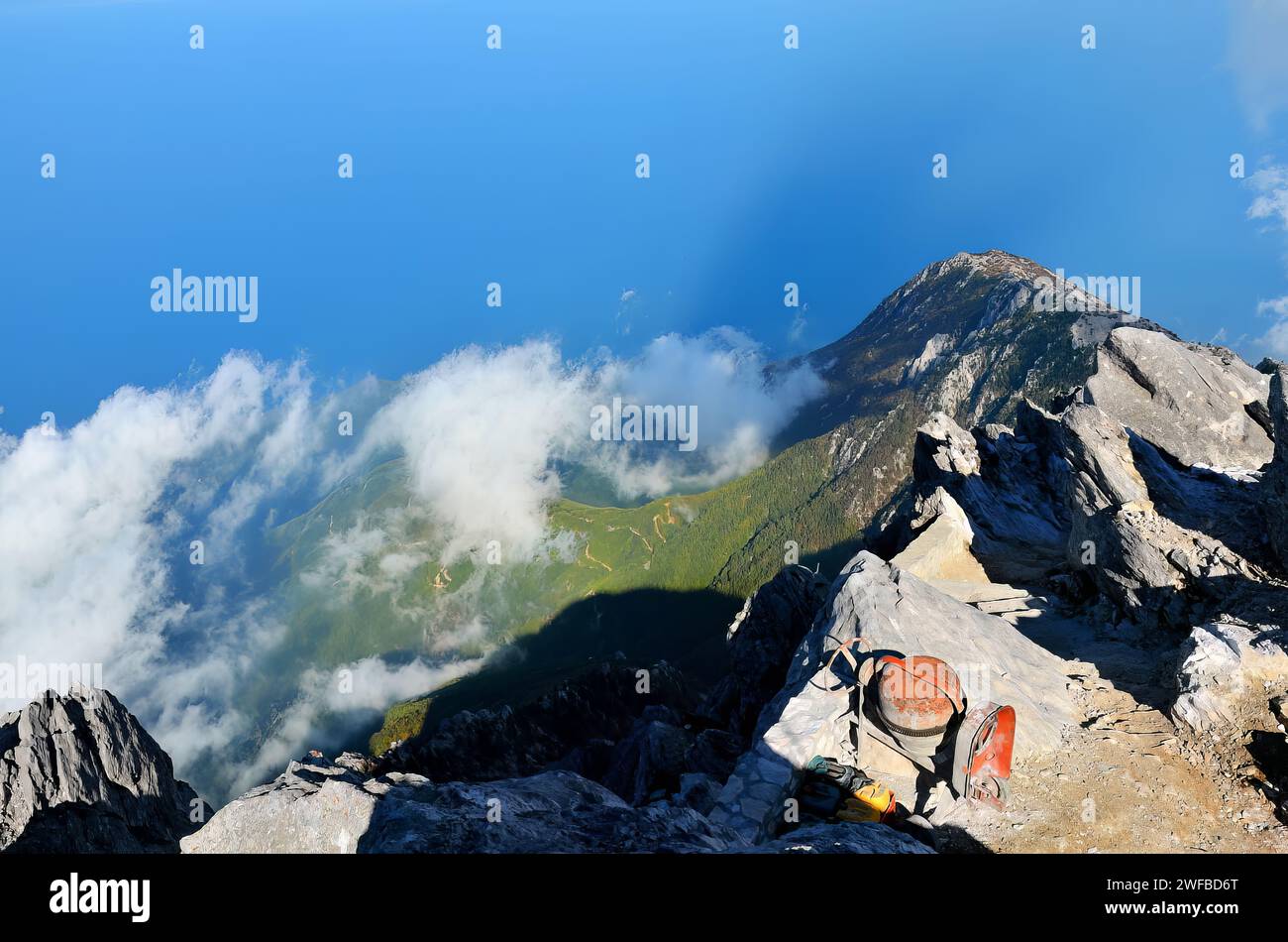 Climbers ascend a mountain with backpacks Stock Photo