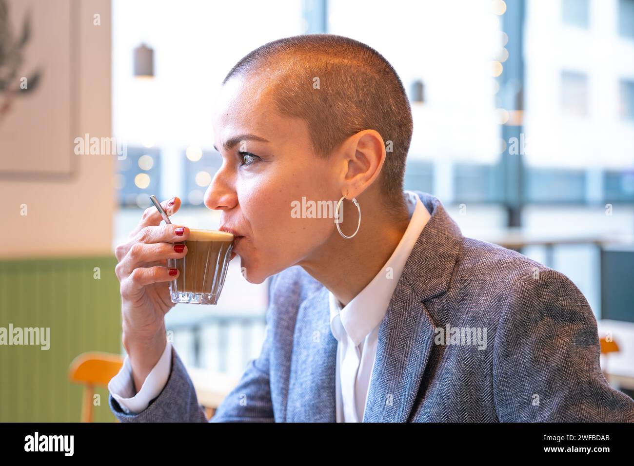 Side view stylish woman drinking coffee in cafe Stock Photo