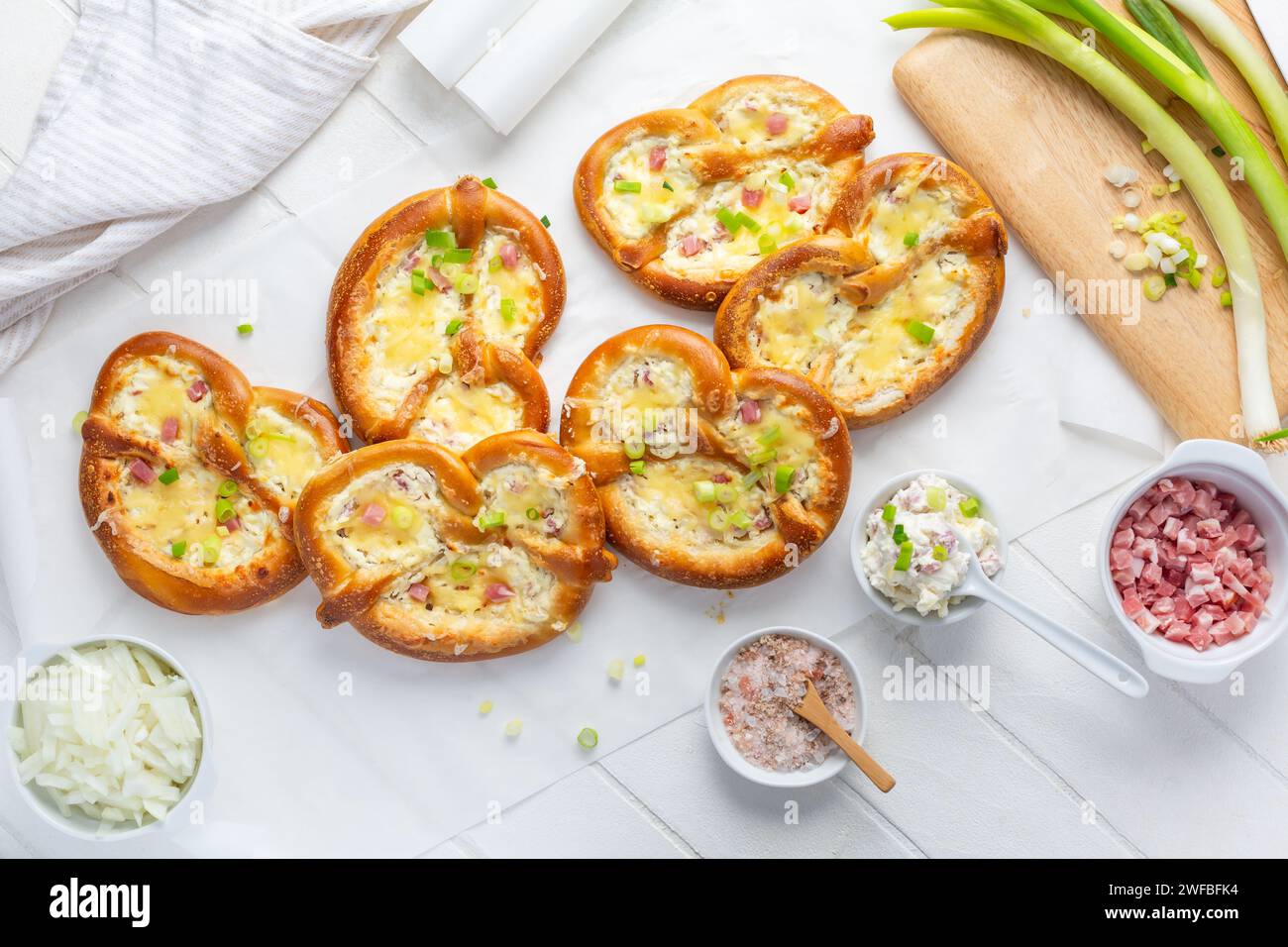 Homemade delicious traditional Bavarian Brezeln or pretzels baked with cream cheese, bacon and onions Stock Photo