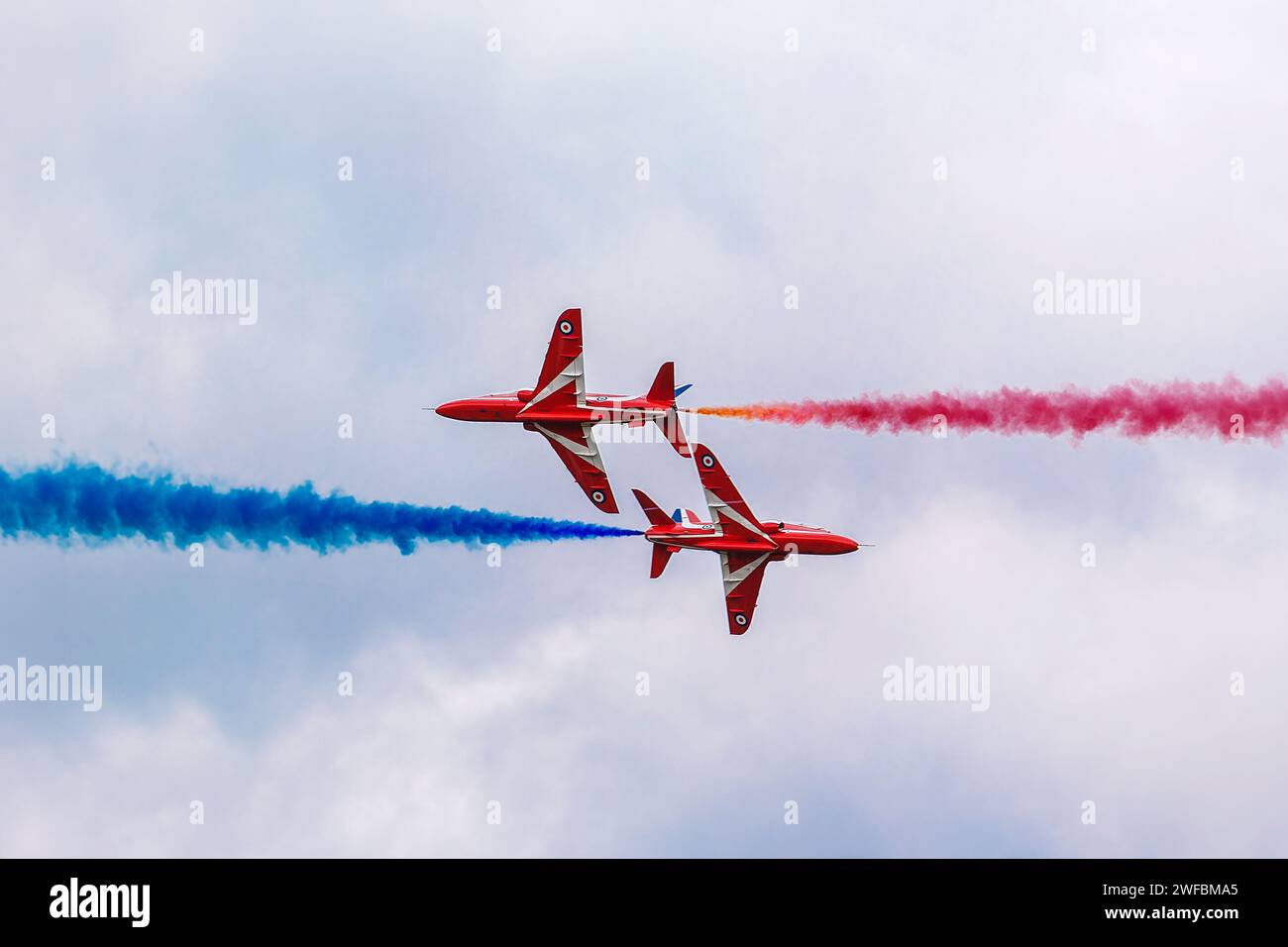 Royal Airforce Red Arrows Hawk T1 jet aircraft perform a flypast during a aerobatic air display in Gloucestershire, England Stock Photo