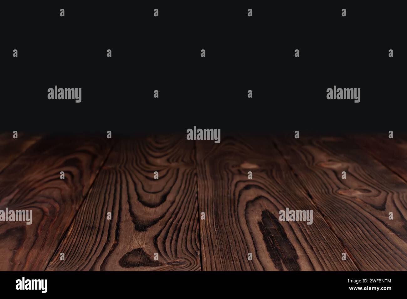 empty wooden table float up on dark background. Stock Photo