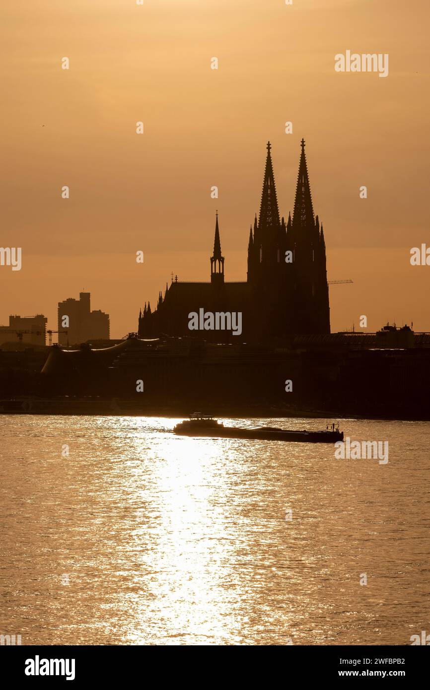 The Rhine with Cologne Cathedral in the background and two barg Stock Photo