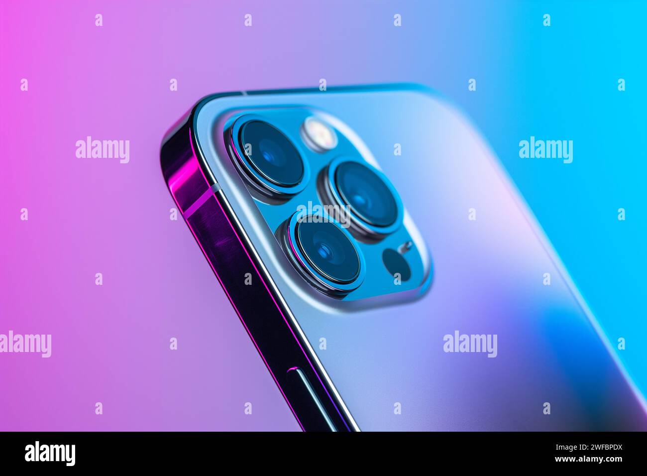 Macro Shot of Triple-Lens iphone 14 pro max Smartphone Camera on Gradient Background Stock Photo
