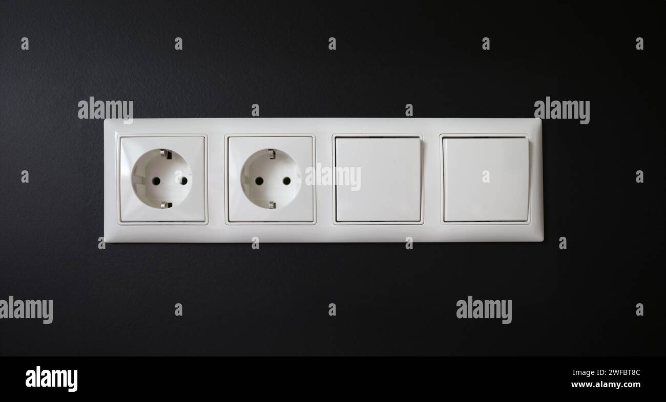 Integrated socket with switches installed in wall Stock Photo
