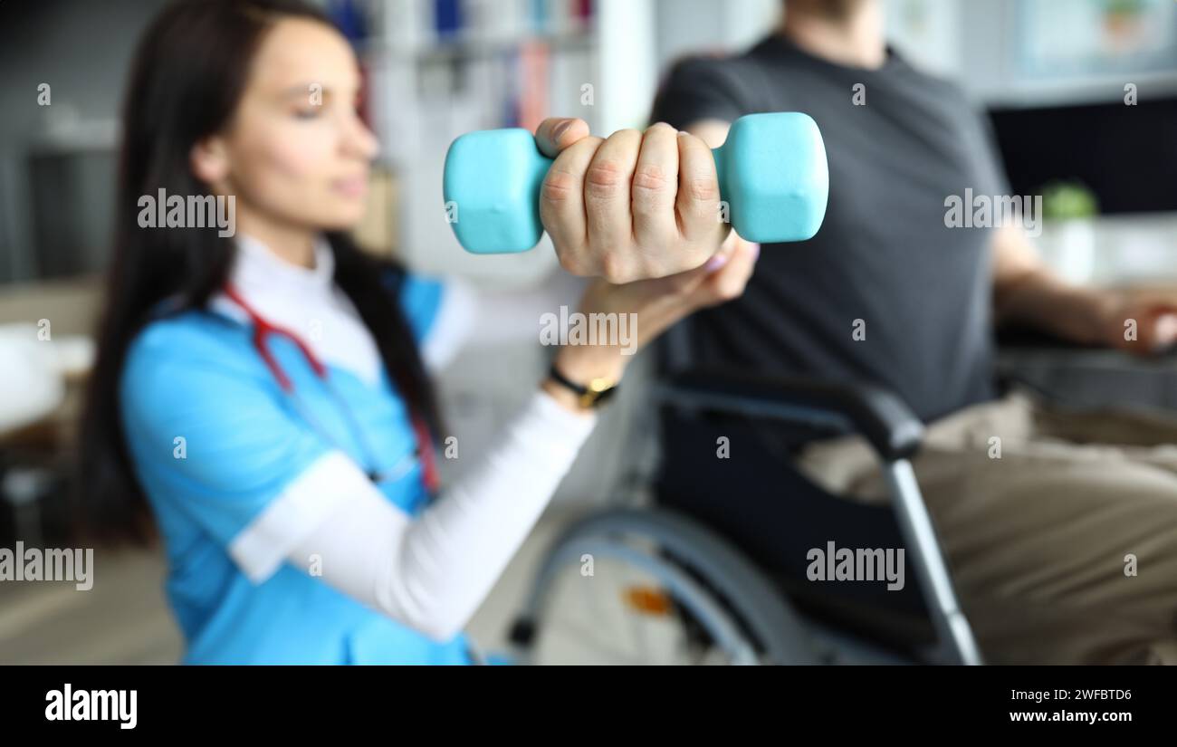 Man on stroller doing exercises with dumbbells Stock Photo