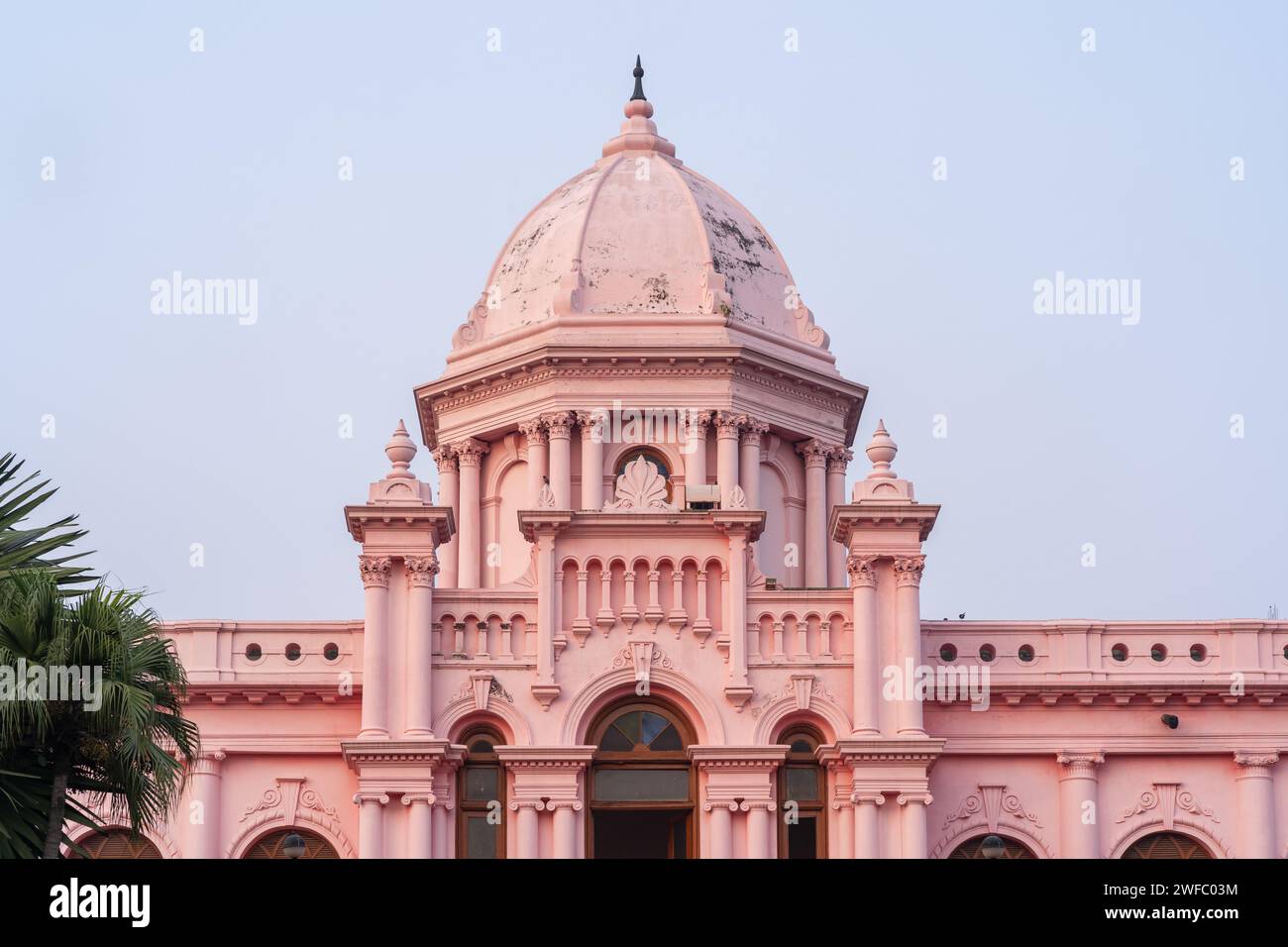 Detail view of the pink facade and dome of historic Ahsan Manzil palace with blue sky background, Kumartoli, Dhaka, Bangladesh Stock Photo