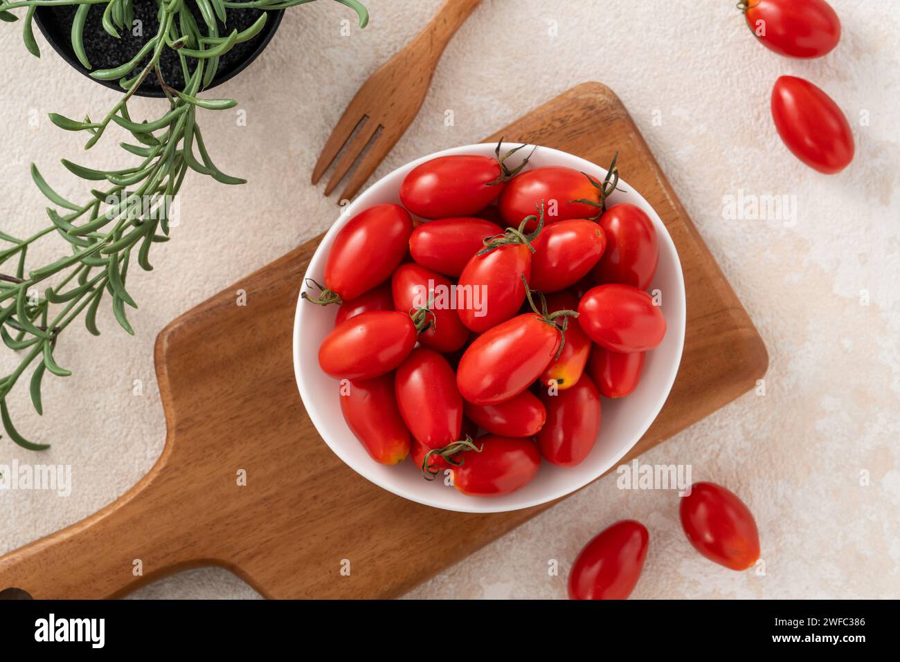 Top view of fresh cherry tomatoes over white table background Stock Photo