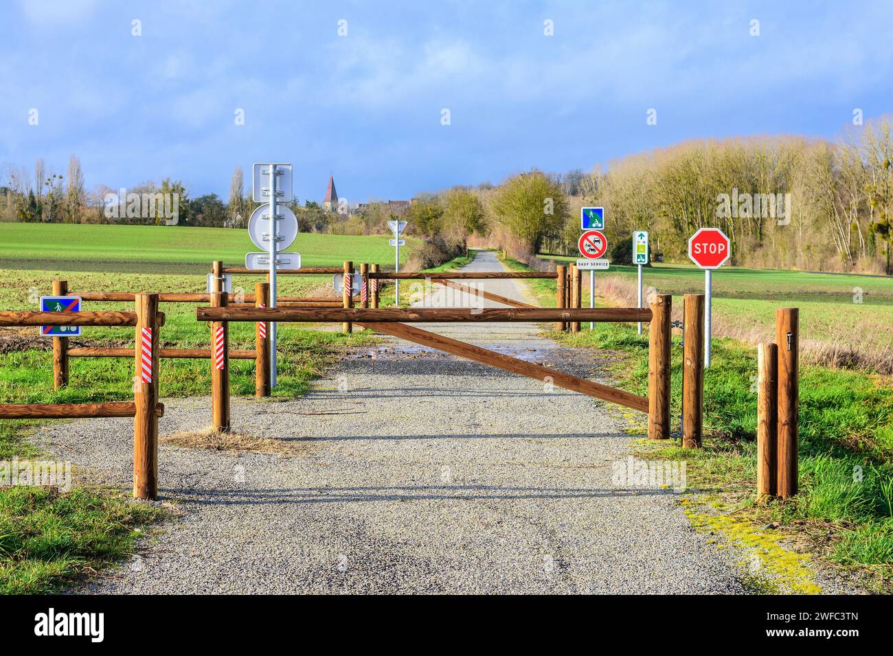 Safety barriers crossing farm track on 'voie verte' (green way) cycle and walking route (former railway) - Preuilly-sur-Claise, Indre-et-Loire France. Stock Photo