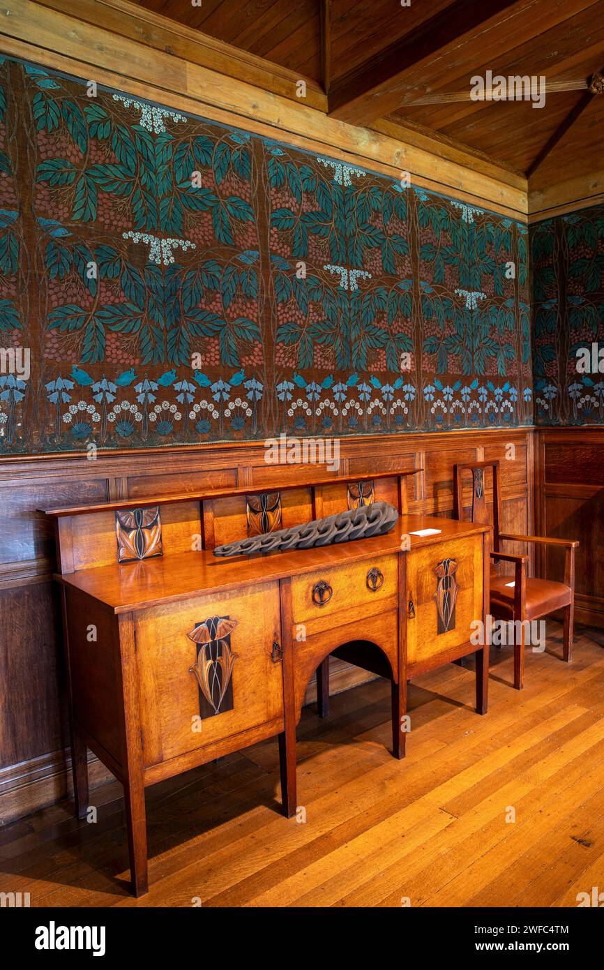 UK, Cumbria, Bowness on Windermere, Blackwell, Arts and Crafts House, Dining Room, Ballie Scott Sideboard and hessian frieze Stock Photo
