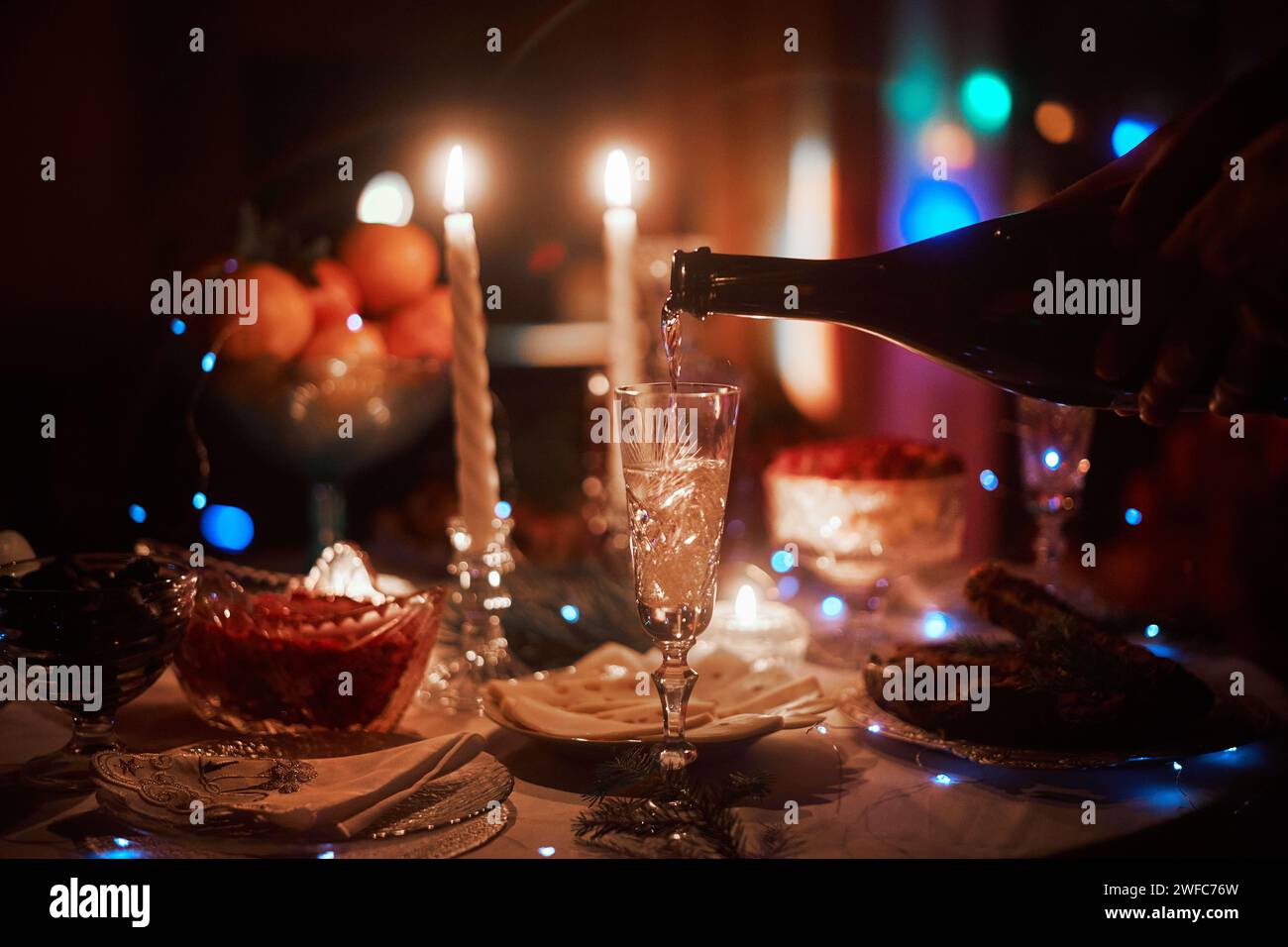 Beautiful retro holiday decor, birthday party. Burning candles and lights in the dark, Christmas Stock Photo
