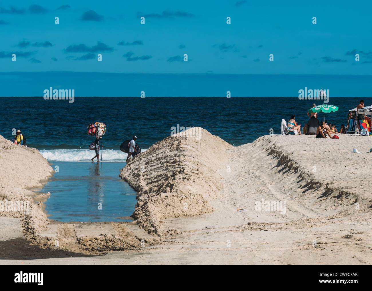 Rio de Janeiro, Brazil - January 29, 2024: A vibrant scene captures beachgoers engaging in various activities on the sandy shores of Copacabana Beach, Stock Photo