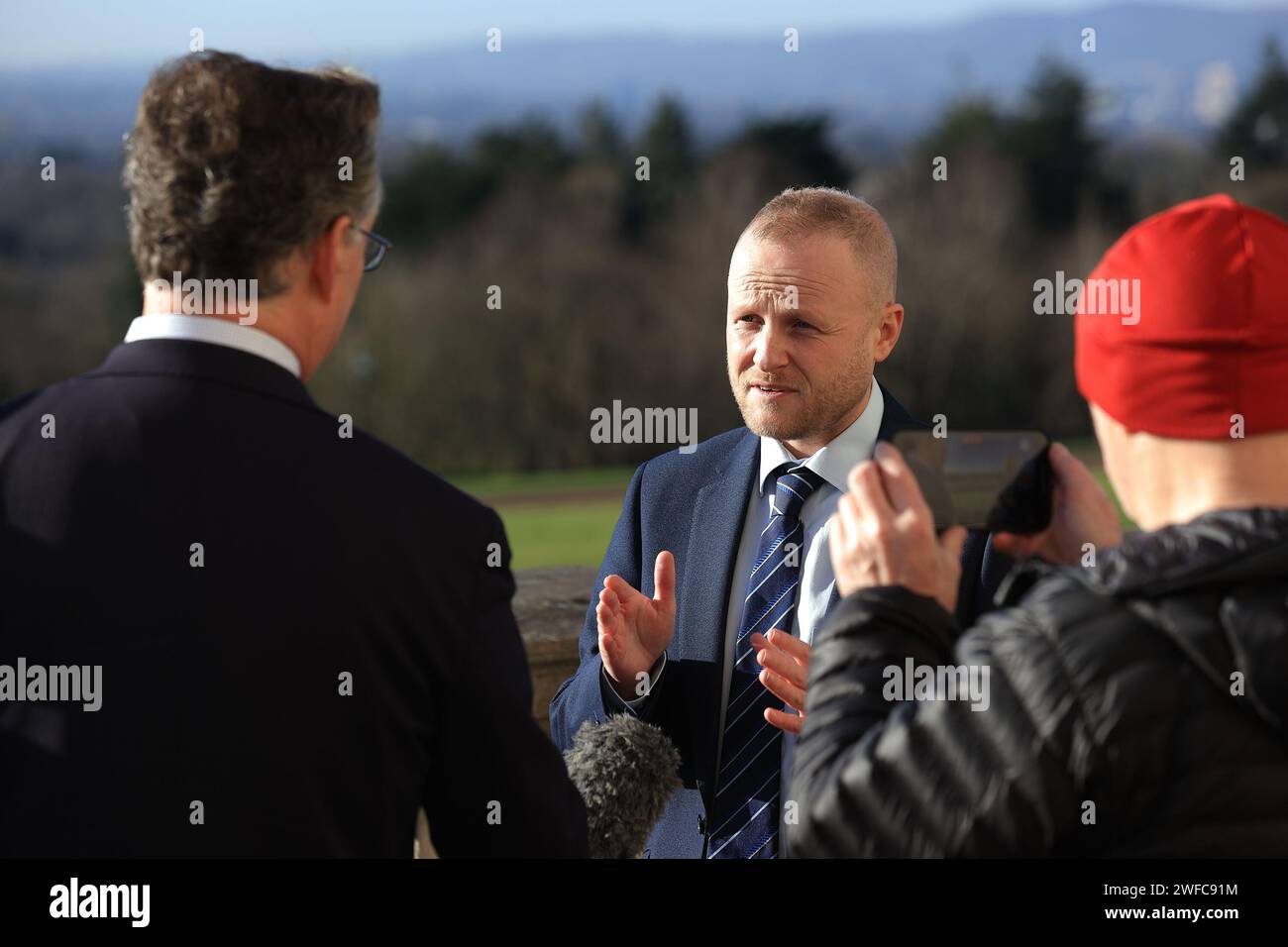 Jamie Bryson, a loyalist activist and vocal opponent of the Government deal speaks to the media outside the Parliament Buildings in Stormont, Belfast, as powersharing in Northern Ireland is set to return after the DUP party executive backed a Government deal aimed at addressing its concerns over post-Brexit trade barriers. Picture date: Tuesday January 30, 2024. Stock Photo