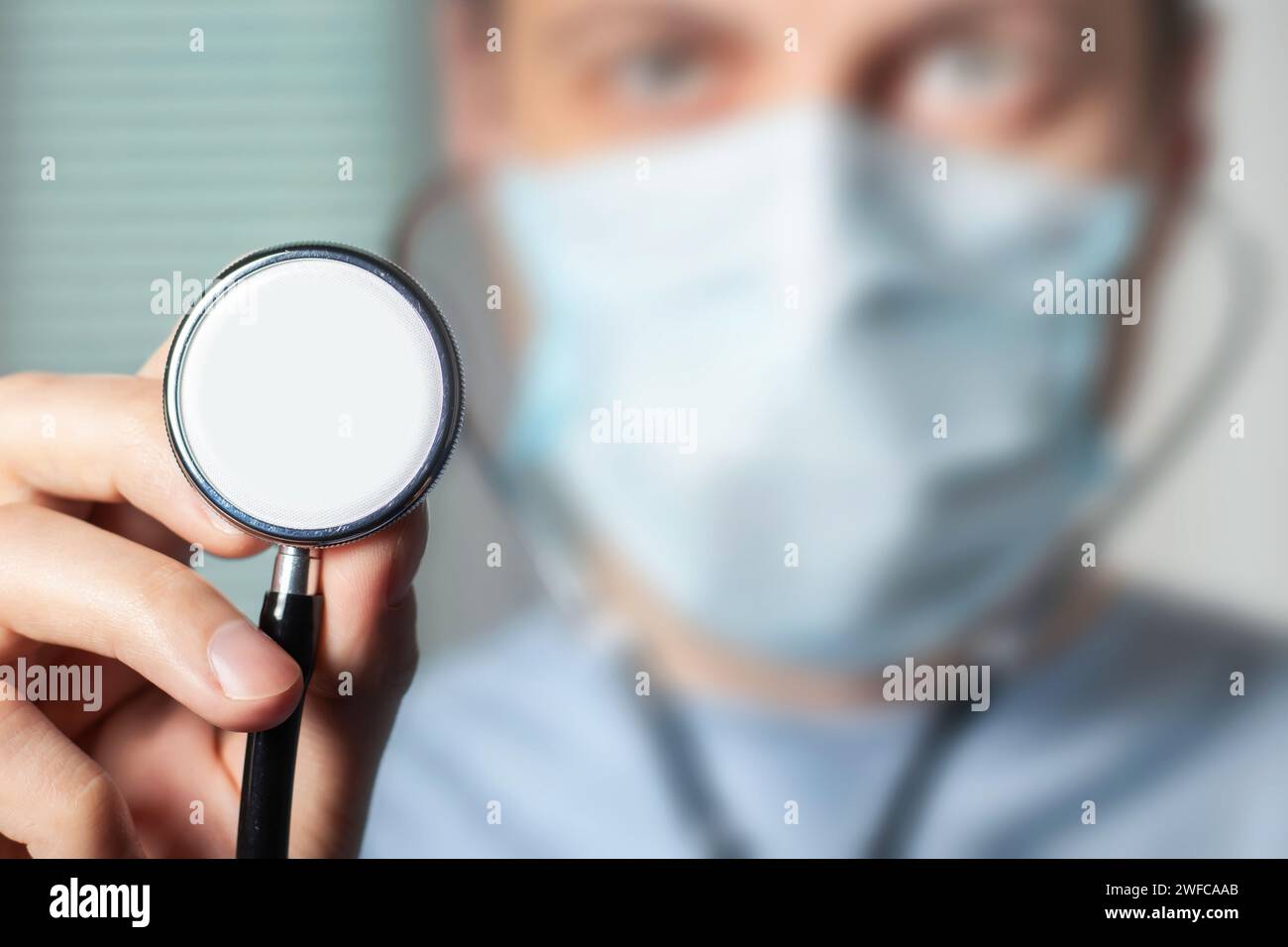 Male doctor showing stethoscope for checkup. Close up of doctor hand