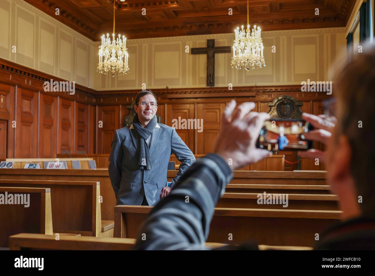 Nuremberg, Germany. 30th Jan, 2024. Alexander Korb, new director of the Nuremberg Trials Memorium, is photographed by a journalist in room 600 of the Nuremberg courthouse. Korb will take over the management of the Nuremberg Trials Memorial on June 1, 2024. The 'main war crimes trial' of the International Military Tribunal against leading representatives of the National Socialist regime took place in Hall 600 from November 20, 1945 to October 1, 1946. Credit: Daniel Löb/dpa/Alamy Live News Stock Photo