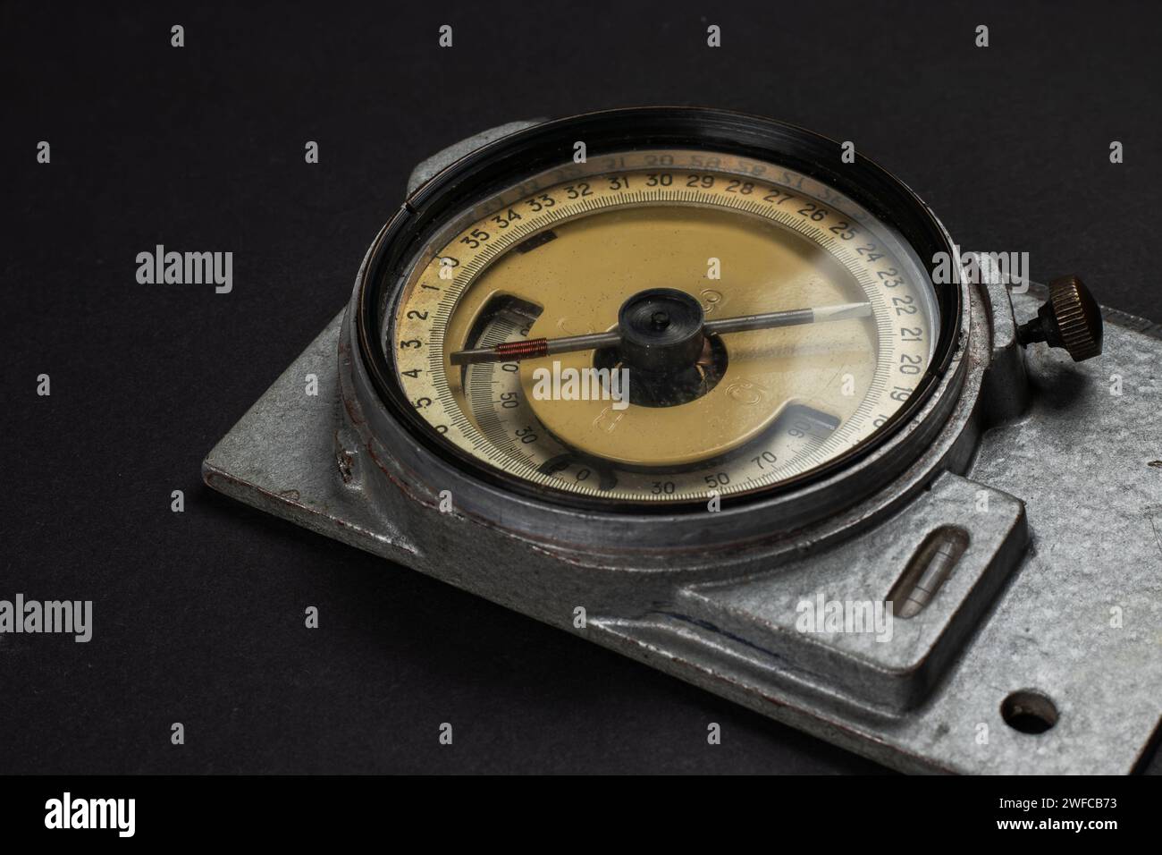 Old mining compass on dark background close up. Stock Photo