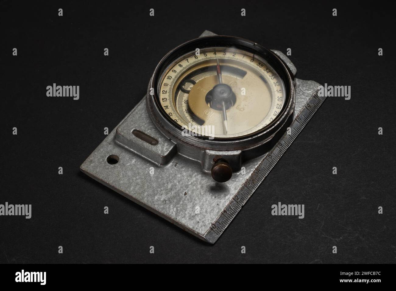 Old geological compass on dark background close up. Stock Photo