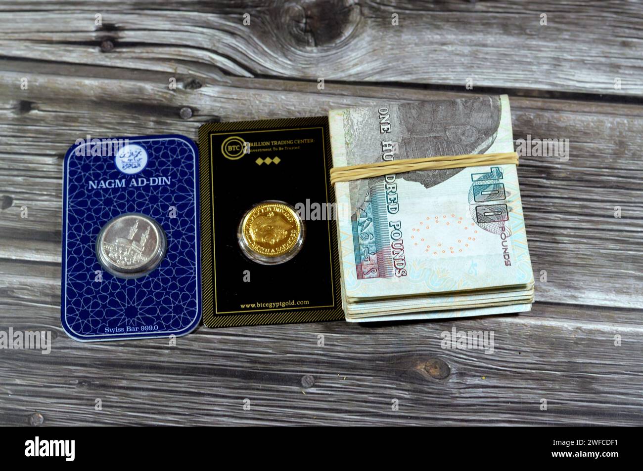 Cairo, Egypt, January 29 2024 Folded Egyptian cash money with BTC Bullion Trading Center gold