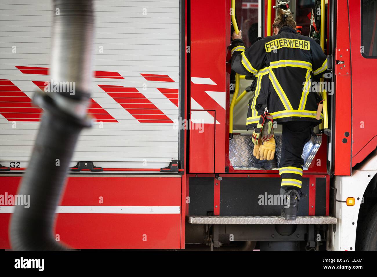 Potsdam, Germany. 30th Jan, 2024. A firefighter gets out of an