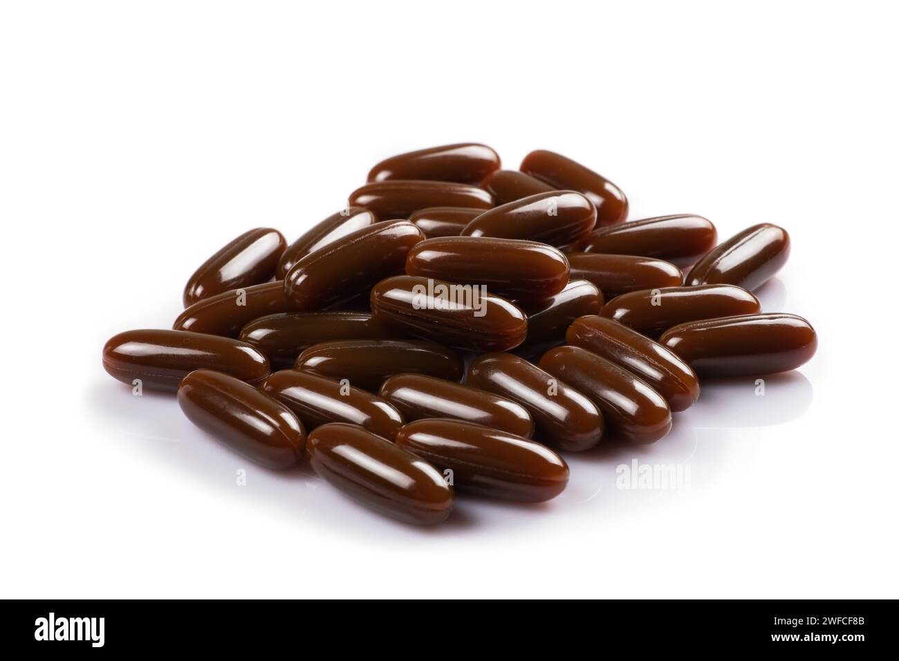 Sunflower lecithin in capsules on a white background. Lecithin in brown