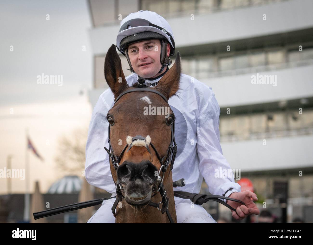 Snowy Evening wins the SBK Novices' Handicap Chase at Doncaster for Oliver Greenall & Josh Guerriero and Henry Brooke on Sun 28 Jan 24 Stock Photo