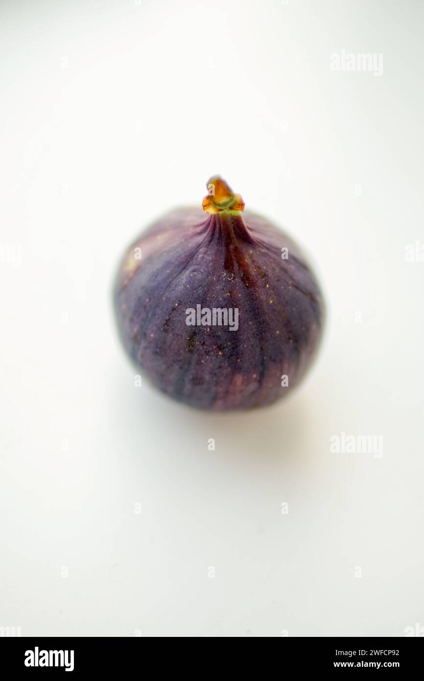 Ripe sweet fig on white blurred table. Selective focus. Stock Photo