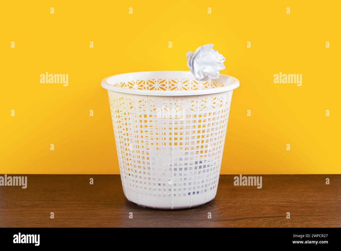 Throw it in the waste paper basket or bin concept for business frustration, stress and writers block. Stock Photo