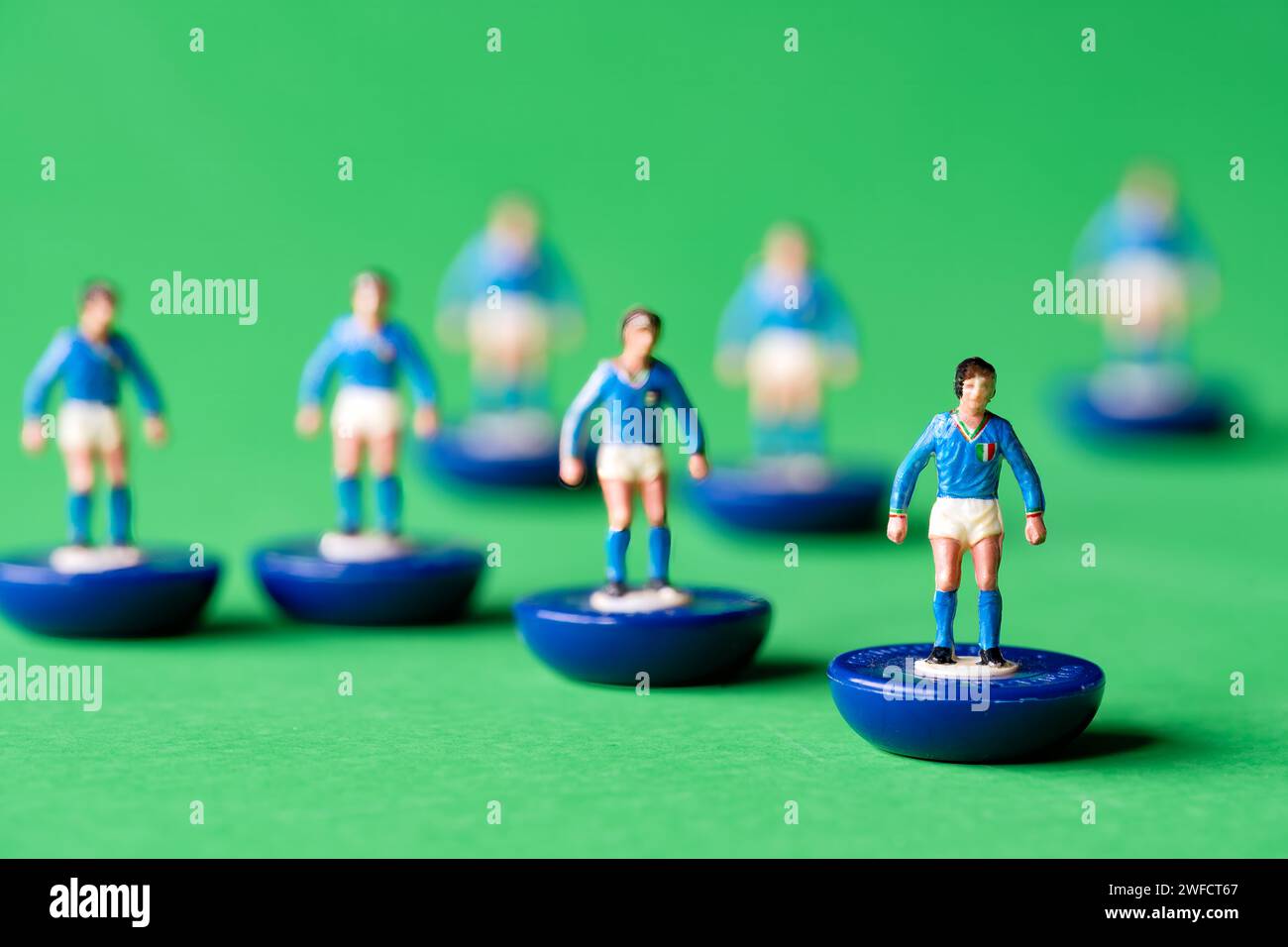 A group of Subbuteo miniature figures painted in the Italy national team colours of blue shirt and white shorts. Subbuteo is a tabletop football game Stock Photo