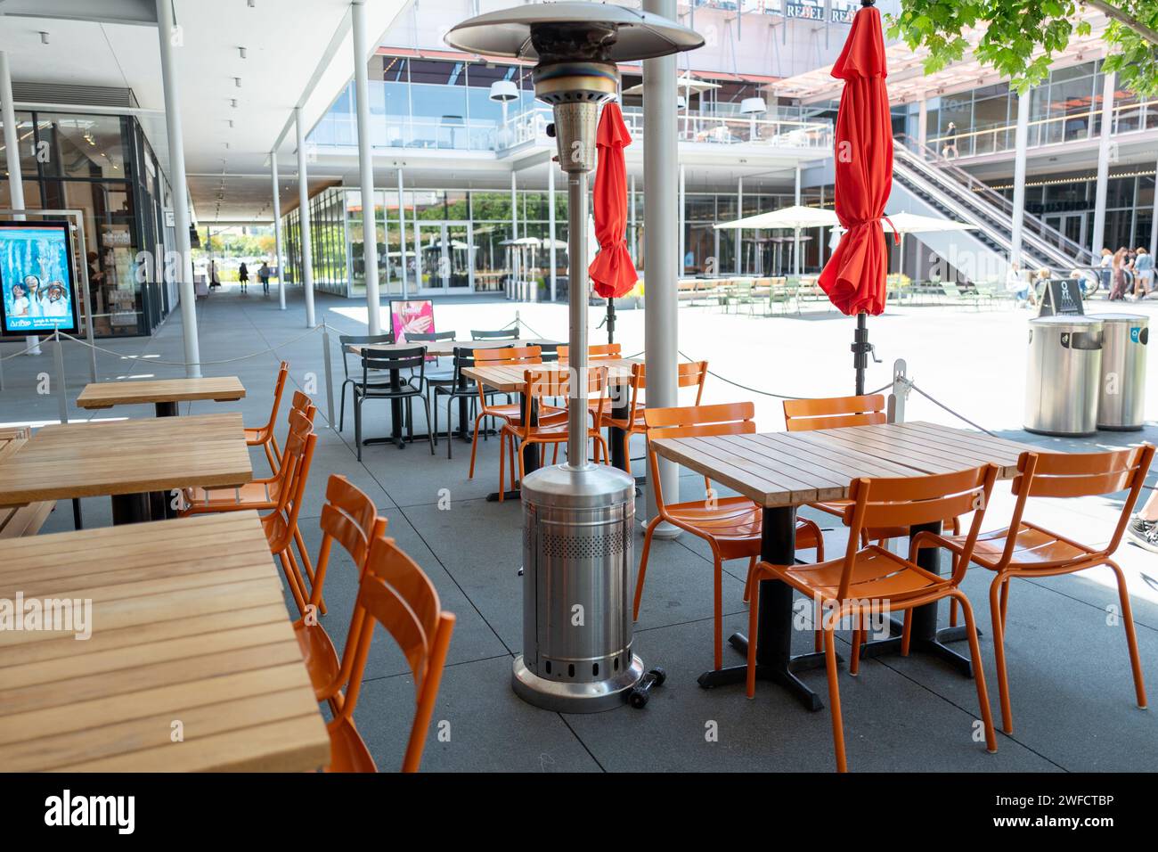 Exterior patio with tables and propane warmers at Delarosa pizza