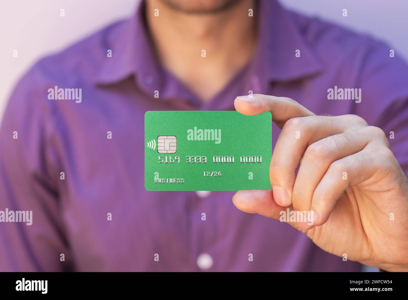 closeup of green credit card holded by hand Stock Photo
