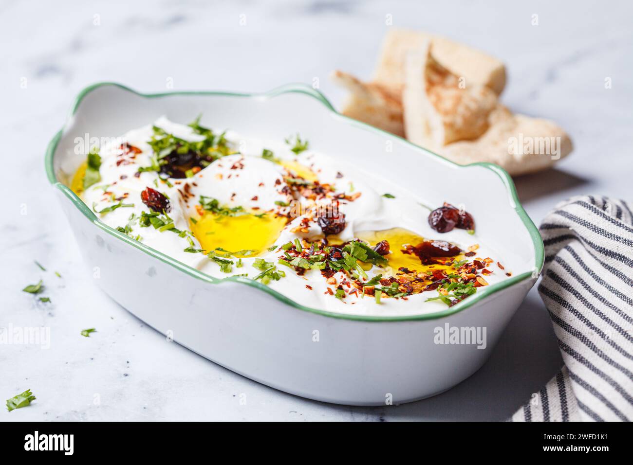 Whipped ricotta dip with chili, oil and cilantro Stock Photo Alamy