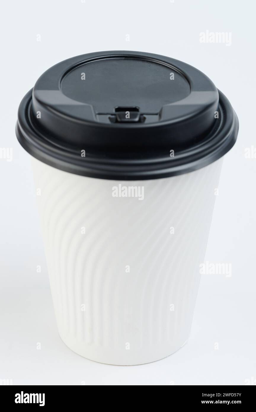 One paper cup mug with black lid isolated on studio background Stock Photo