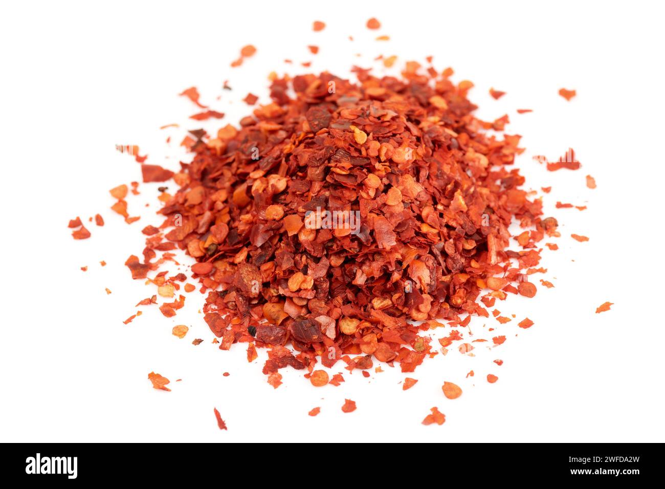 Pile of red chili pepper flakes isolated on white background Stock