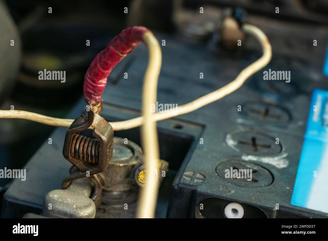 car booster jumper cables charging automobile discharged dead battery close up. Stock Photo