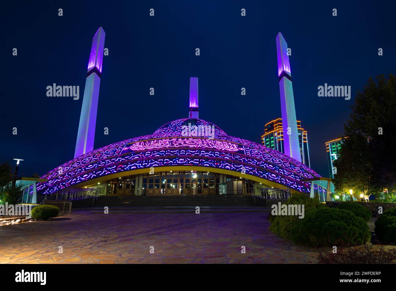 ARGUN, RUSSIA - SEPTEMBER 28, 2021: Mother's Heart Mosque in lilac night lighting on a September night Stock Photo