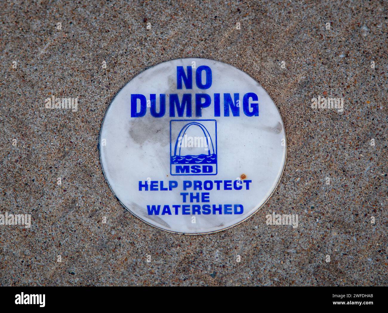 No dumping plaque near a gutter. Stock Photo