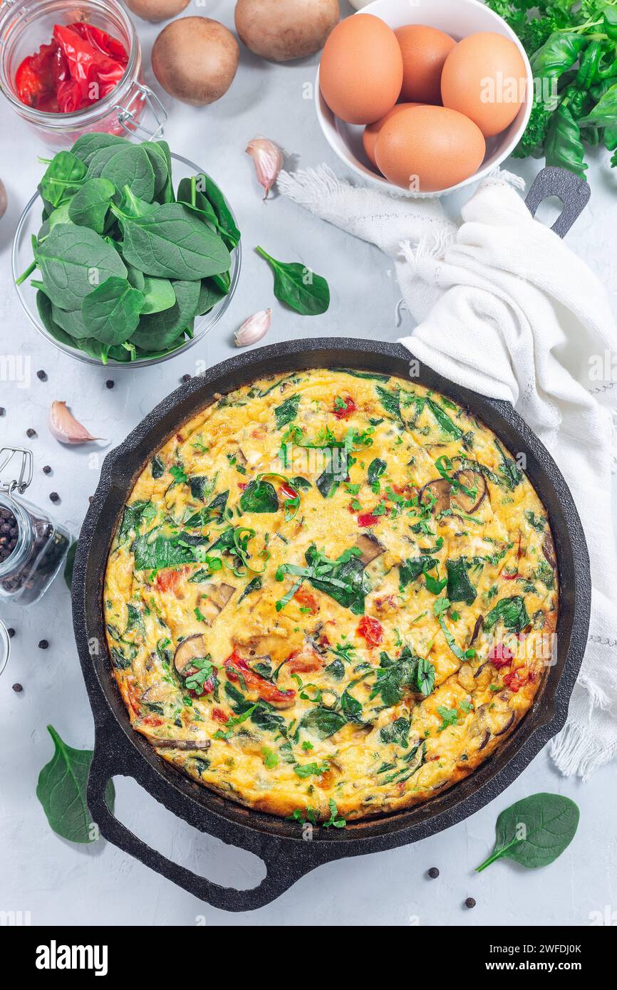 Brunch egg frittata with spinach, roasted red peppers, mushrooms