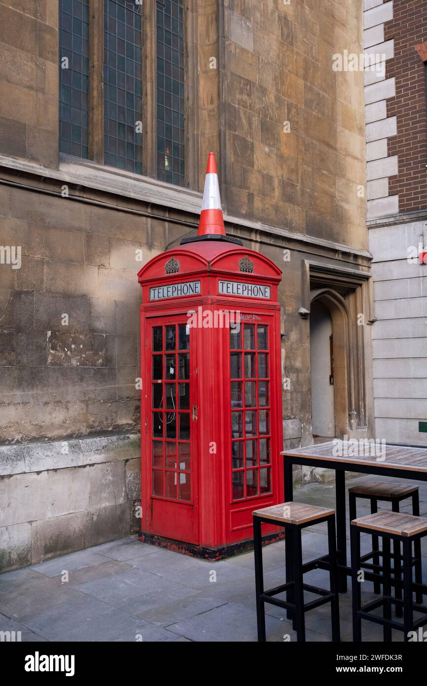 Traffic cone on top of a red telephone box on 18th January 2024 in London, United Kingdom. Stock Photo