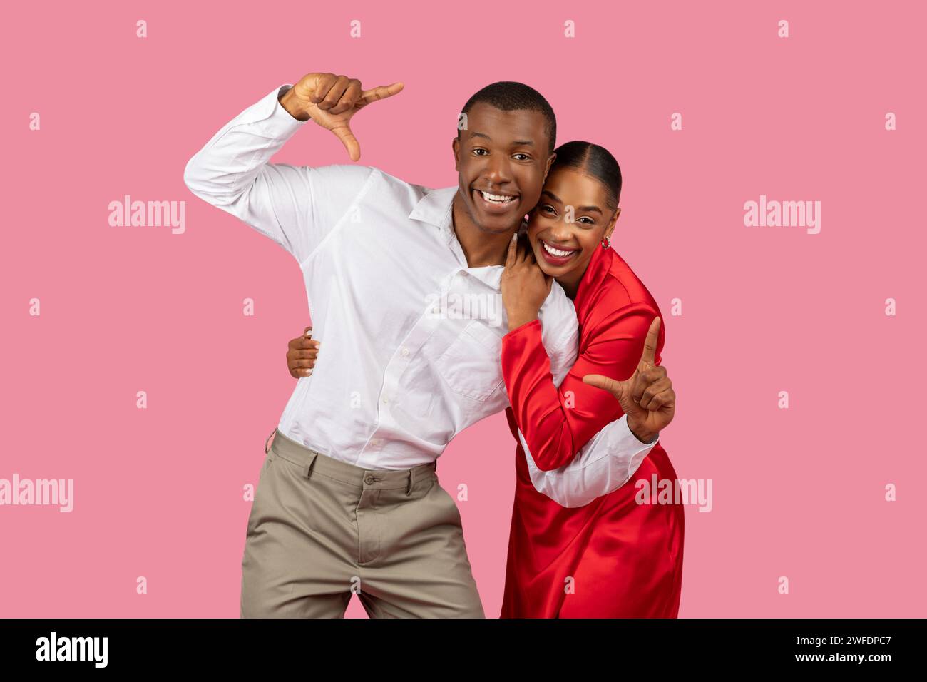 Playful couple making fun hand gestures, joyful Stock Photo