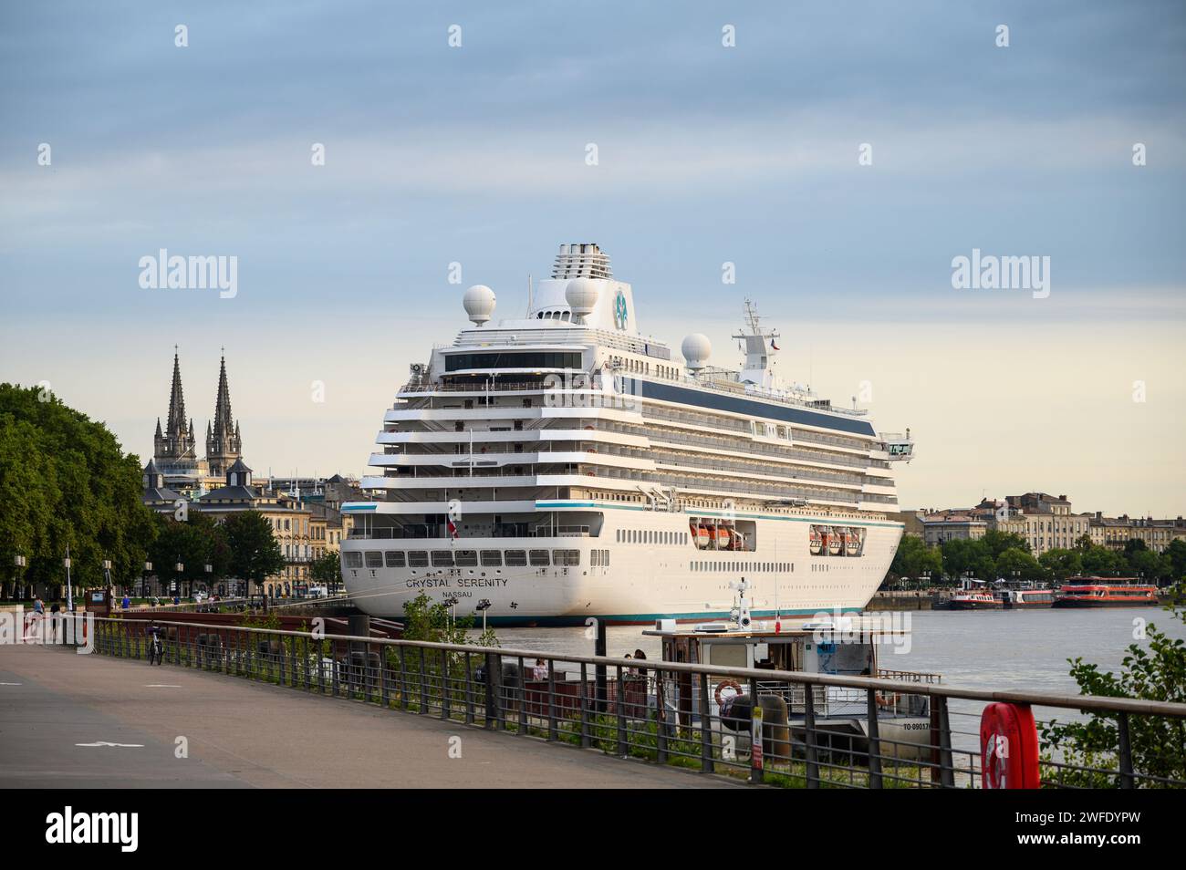 A tourist cruise ship docked in the centre of the French city of Bourdeaux on the Garonne River. Stock Photo