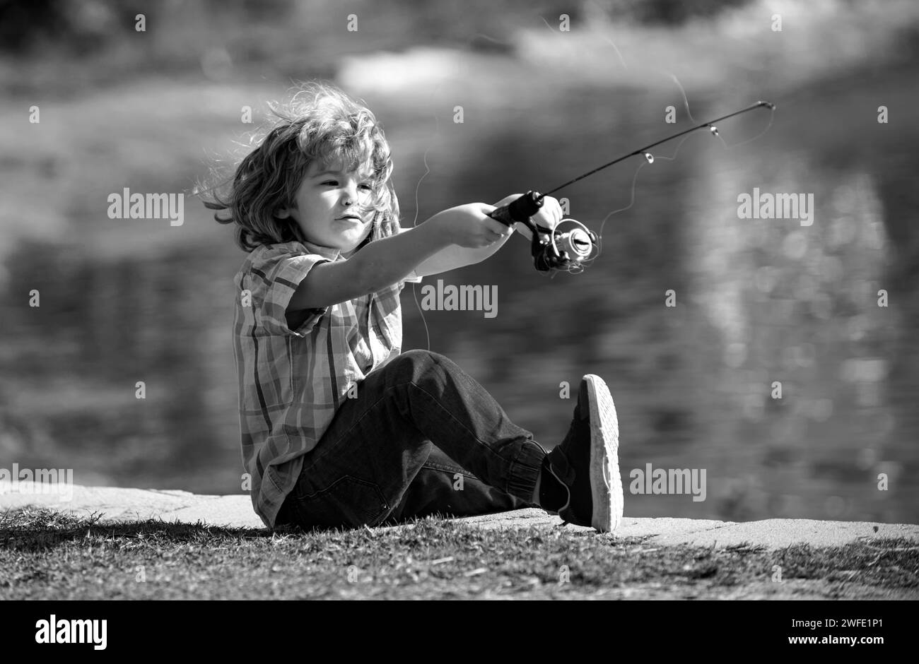 Boy fishing on small lake Black and White Stock Photos & Images